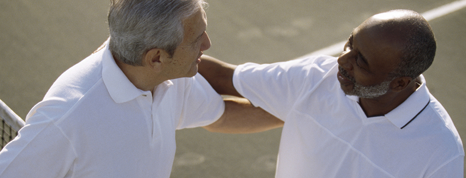 two men greeting on the tennis court