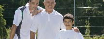 Generations of men on tennis court