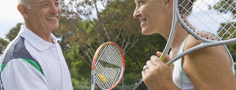 man and woman on the tennis court
