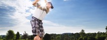 Young man on course doing golf swing