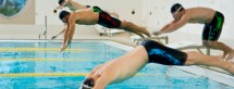 Men swimmers competing in race